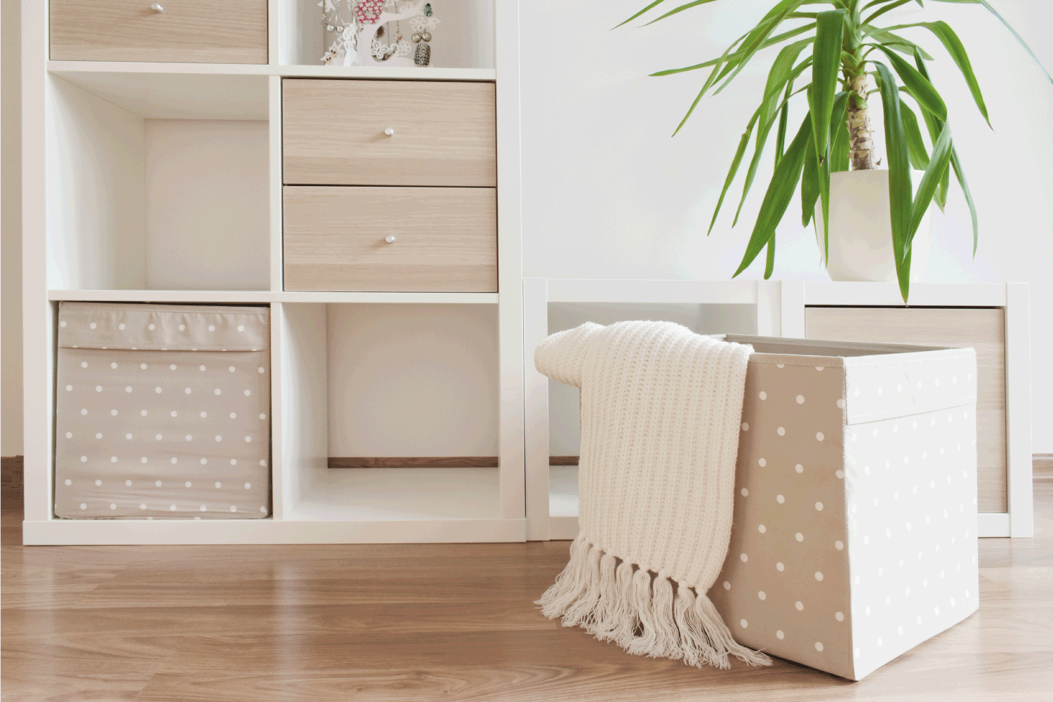 Modern furniture, white shelves, cozzy home interior. decorative boxes
