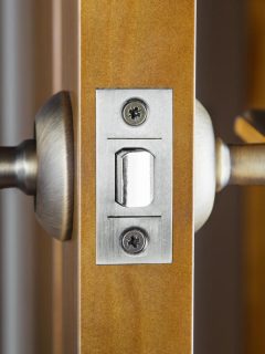 An opened wooden door with latch handle, Door Latch Won't Retract When Closing - What To Do?