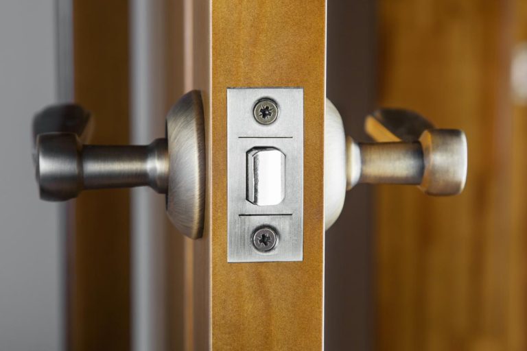 An opened wooden door with latch handle, Door Latch Won't Retract When Closing - What To Do?