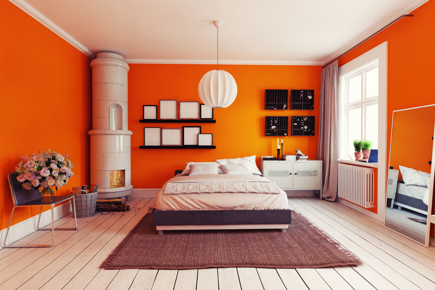 Orange painted walls inside a spacious bedroom with white flooring, a small fireplace on the side and white beddings