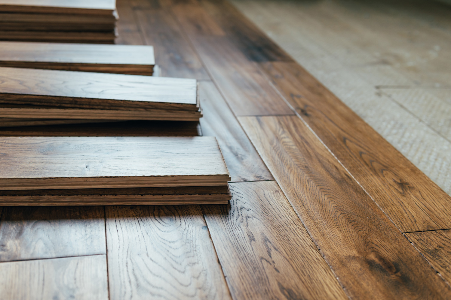 The process of house renovation with changing of the floor from carpets to solid oak wood.
