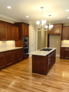 Ultra rustic classic kitchen with dark oak cabinets and cupboards matched with white marble countertop, How High Should Kitchen Counters Be?