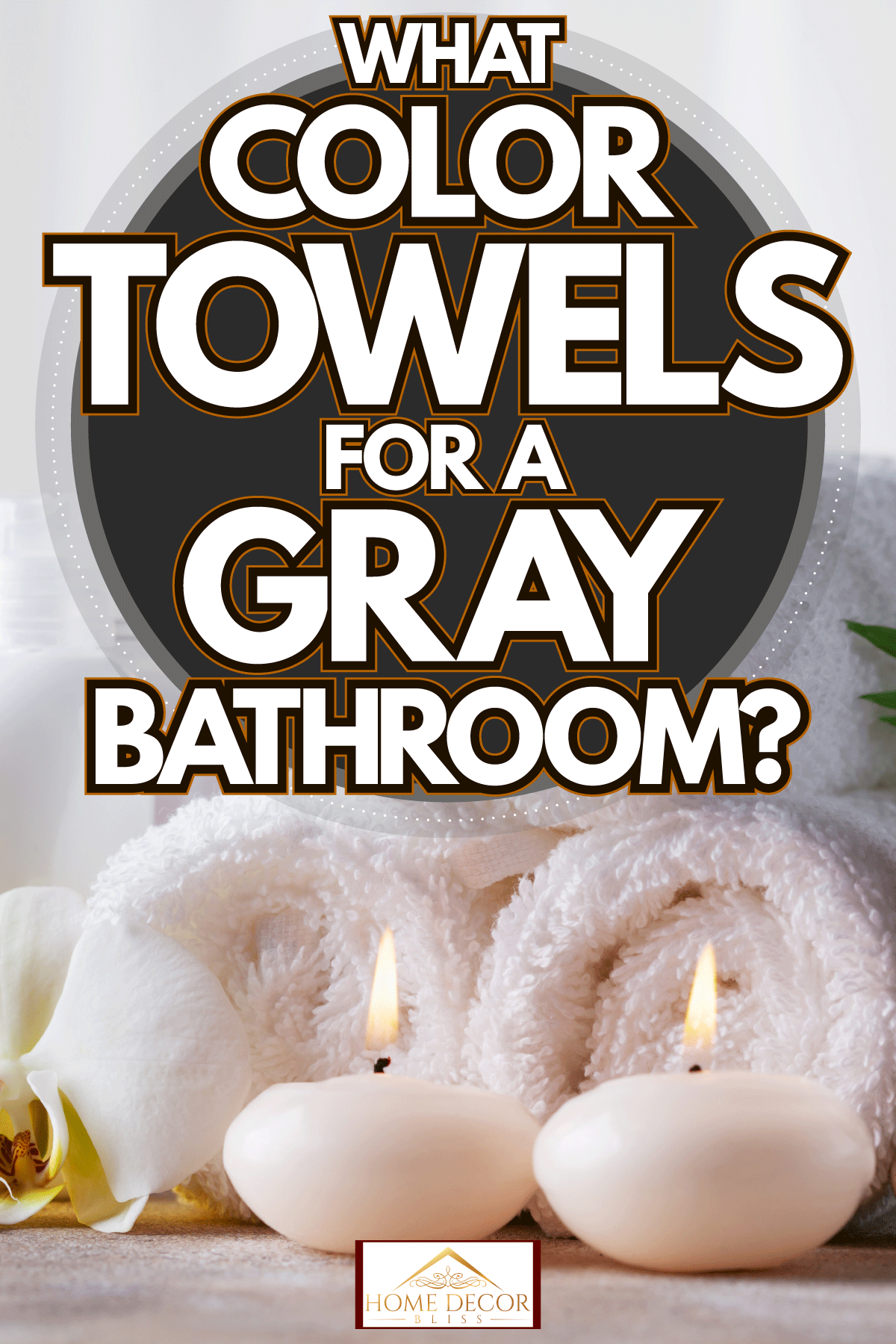 Three white rolled towels with candles on the side and essential oils, What Color Towels For A Gray Bathroom? 