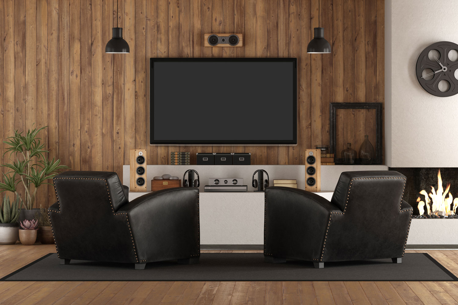 Wooden panel theatre room with black leather sofas and wooden flooring