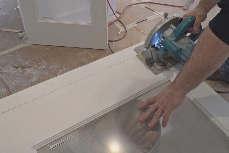 man using a circular saw for cutting wood door construction and home renovation, repair tools - How To Fix Gaps In Door Trim