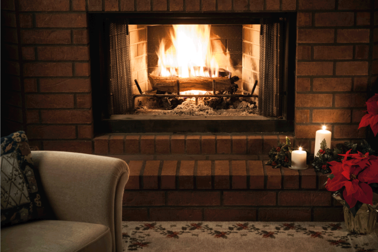 simple holiday season livingroom fireplace scene, lit by a blazing fire and candle light. How To Decorate Walls On Either Side Of Fireplace