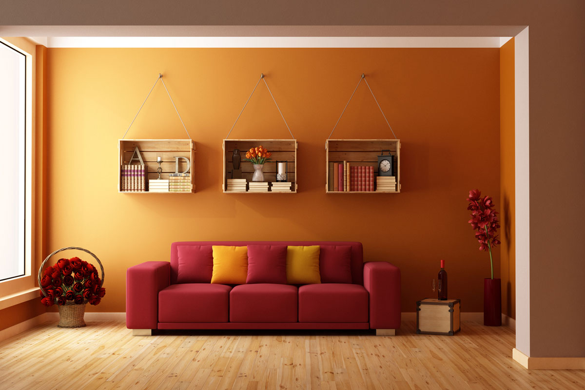 Living room with red sofa and wooden crates used as a bookcase