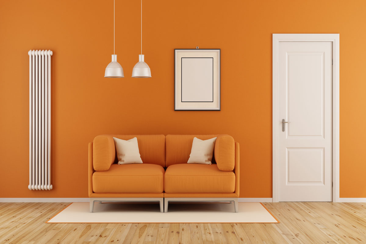Orange living room with modern couch,closed door and vertical heater
