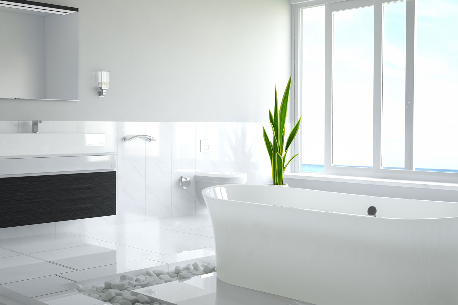 A bright and white designed bathroom with pebbles surrounding the bathtub area and a snake plant on the side