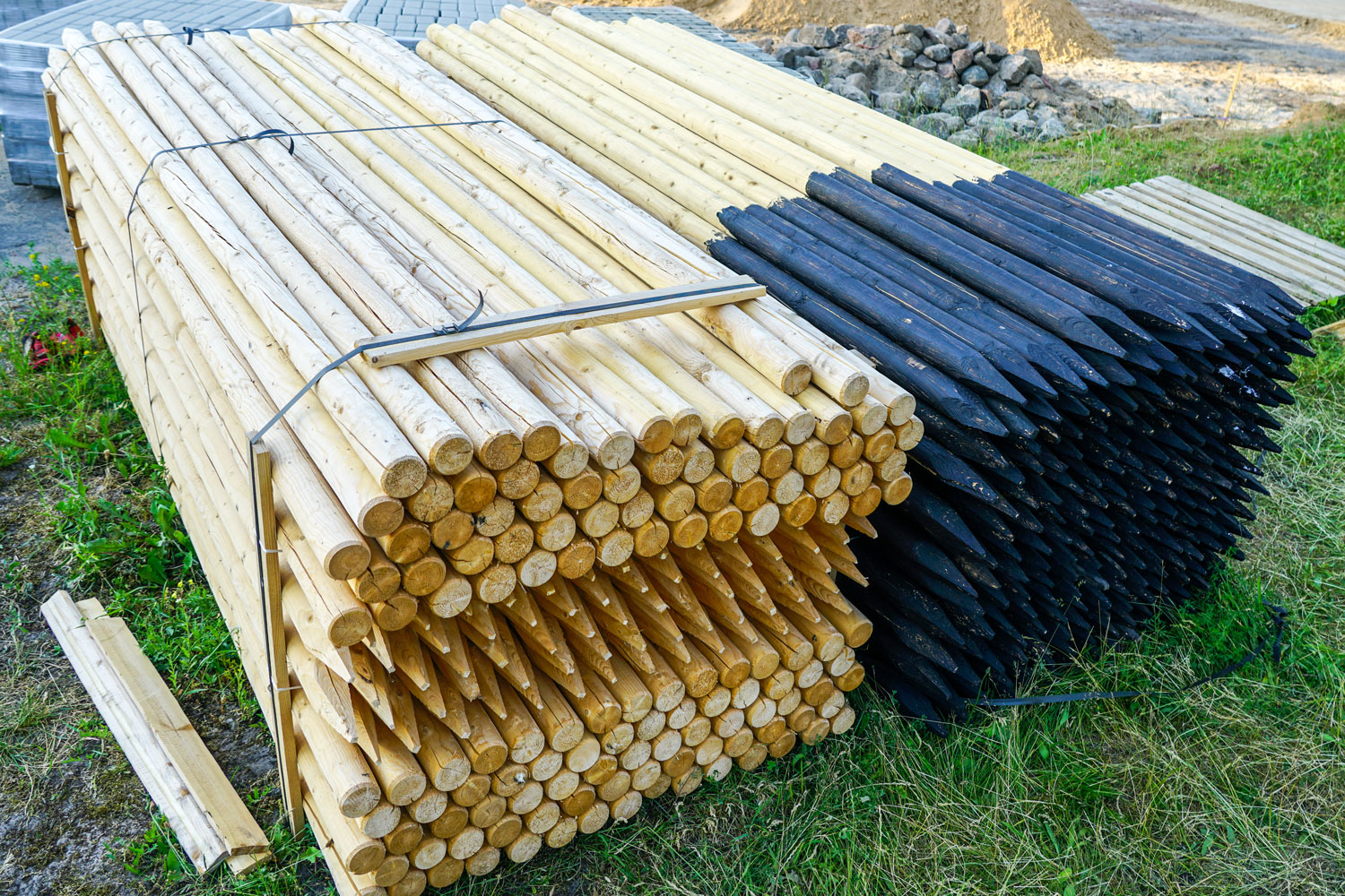 A huge bundle of fence posts for a house under construction
