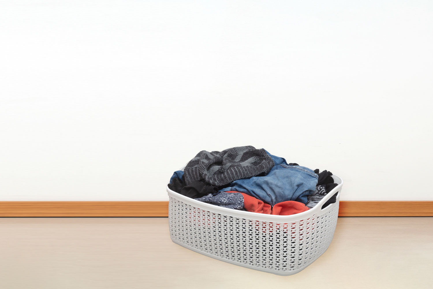 A small laundry basket placed on the side