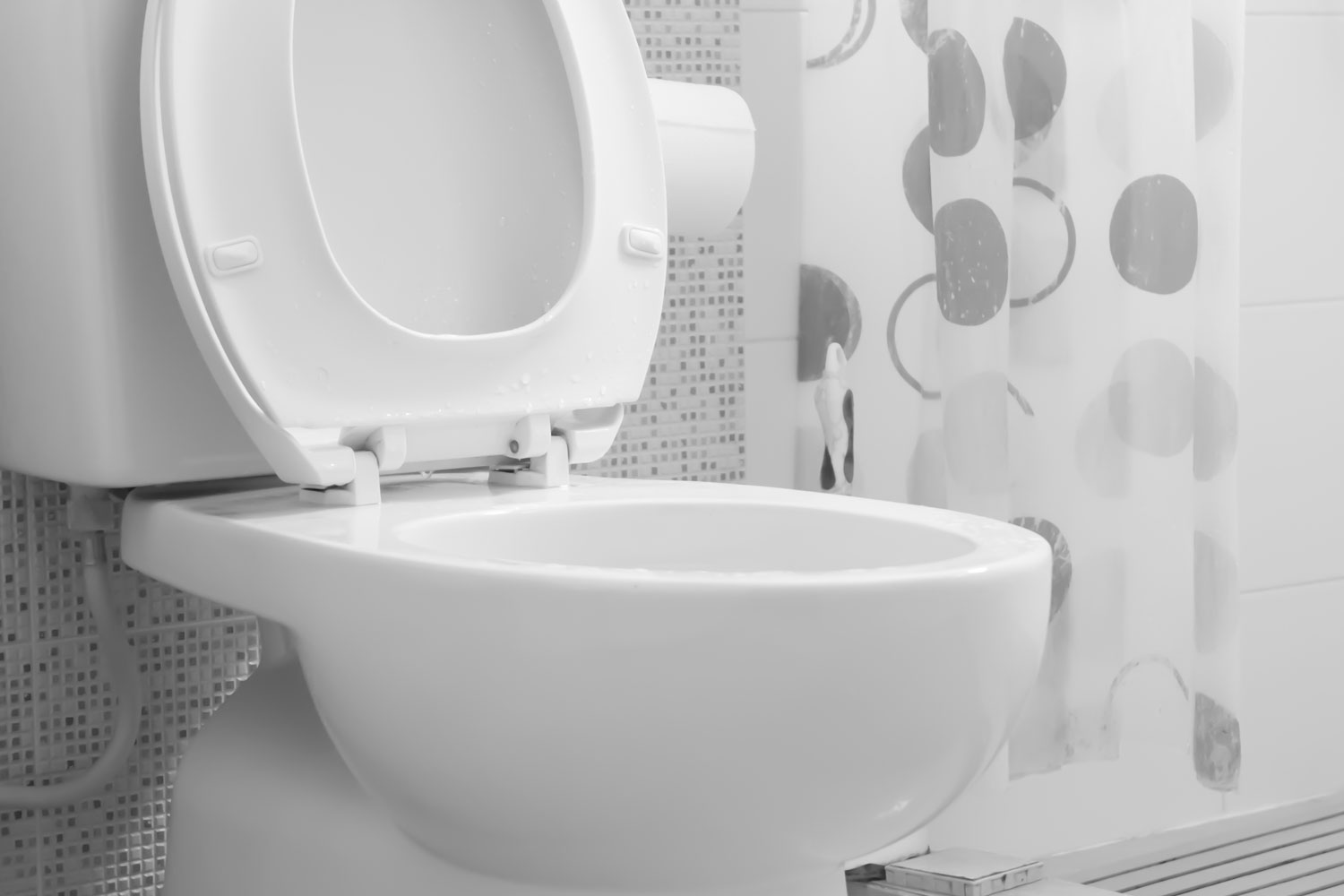 A white toilet inside a bright patterned bathroom