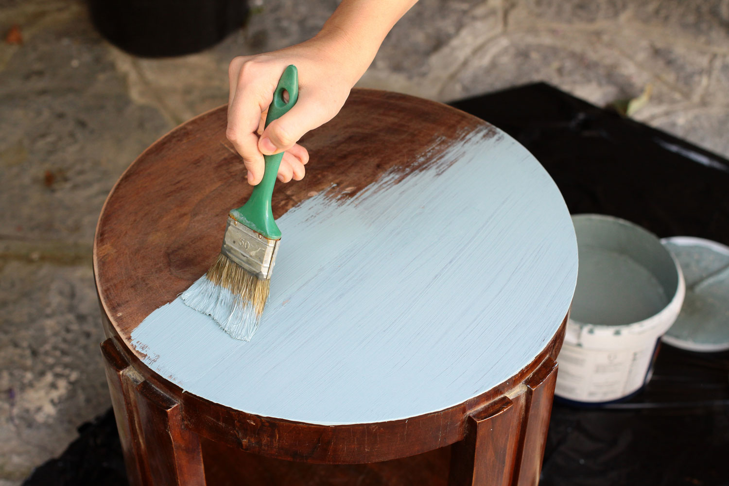 Carpenter painting a chair with chalk paint