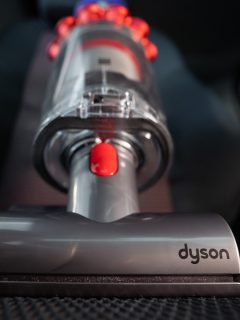 Close up of the Mini motorhead of Dyson Cyclone V10 Fluffy vacuum cleaner on car seats with car interior background. Ready for cleaning - Dyson Handheld Keeps Cutting Out—What To Do
