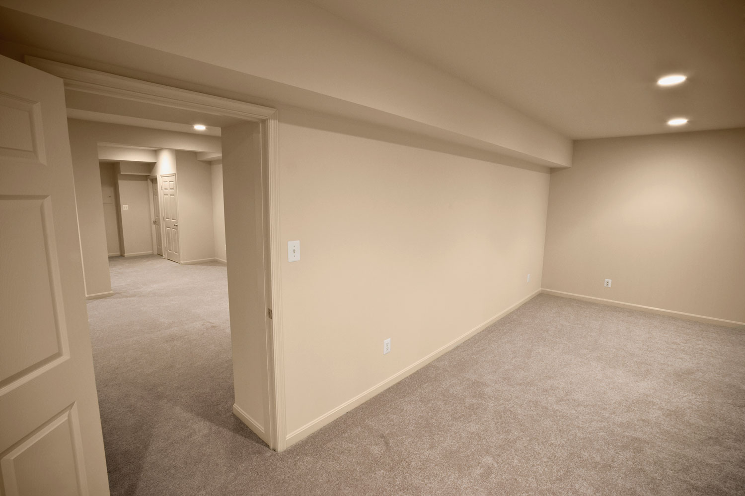 Cream painted walls, carpeted flooring inside an empty living room