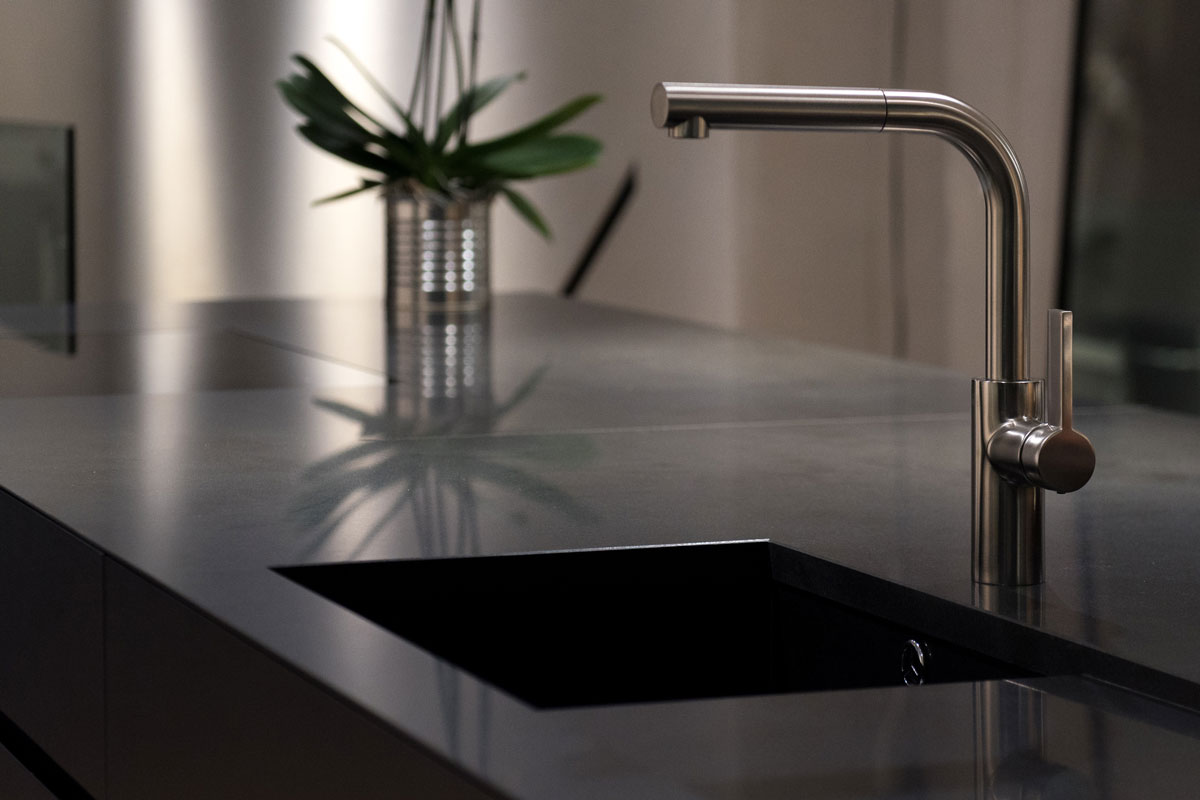 Dark Solid Granite Sink with Modern Stainless Steel Faucet Tap