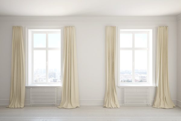 Empty room with long curtains on the windows - Best Curtain Lengths [By Ceiling Height]