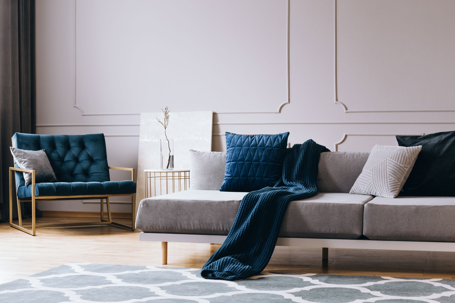 Gray sofas and chairs with blue foam and throw