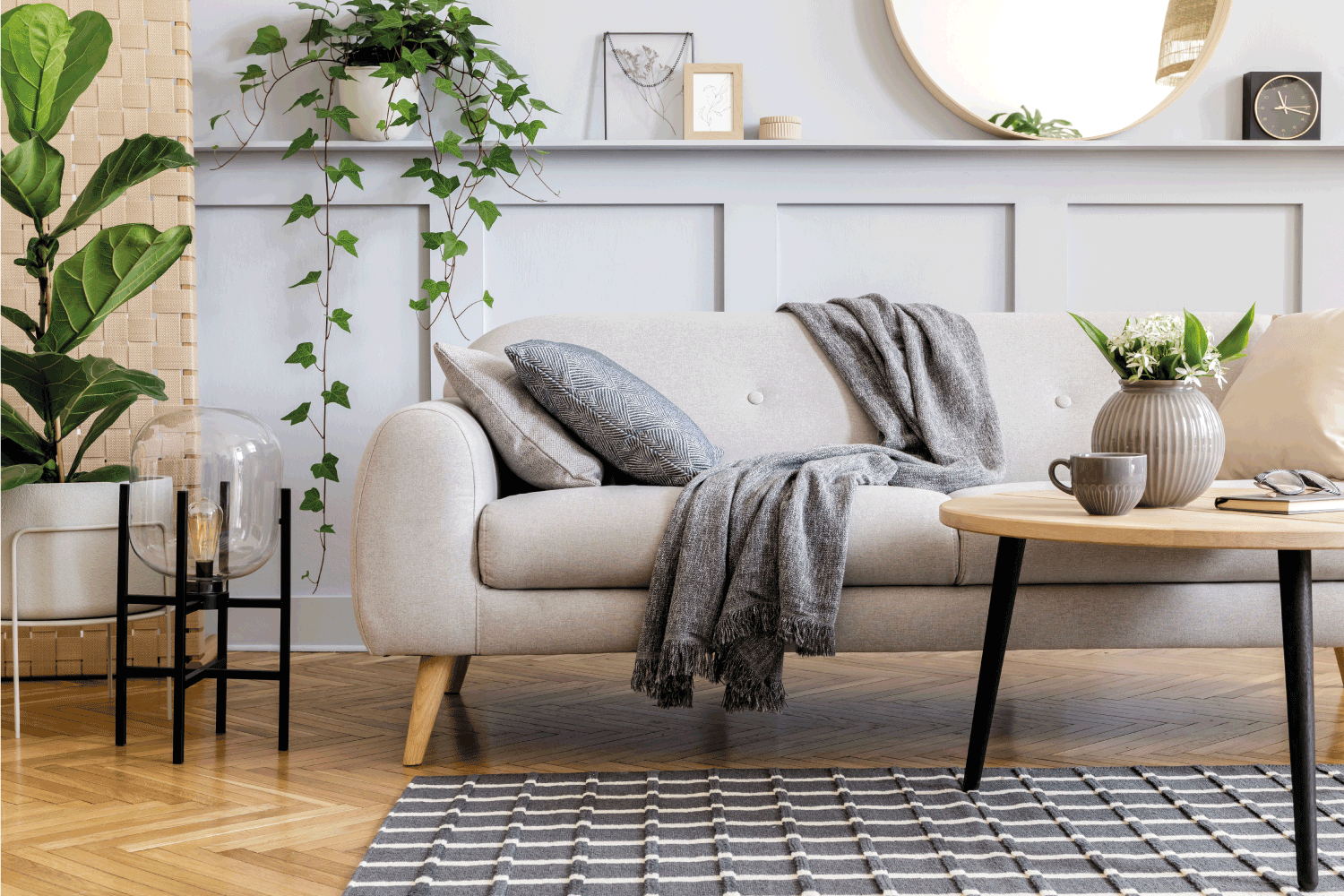 Grey And Beige Living Room scandinavian living room interior with design sofa, furniture, tropical plants and decoration. Grey wall. Neutral concept