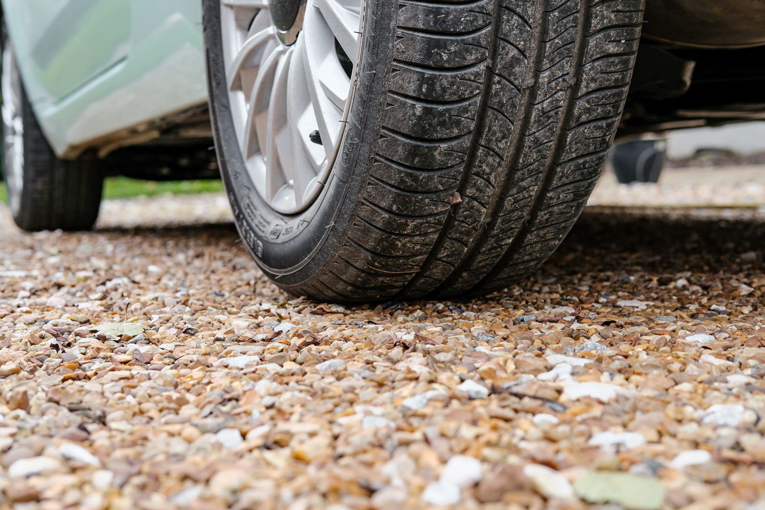 Ground level view of a new car, showing the rear tyre and tread together with the alloy wheel. 