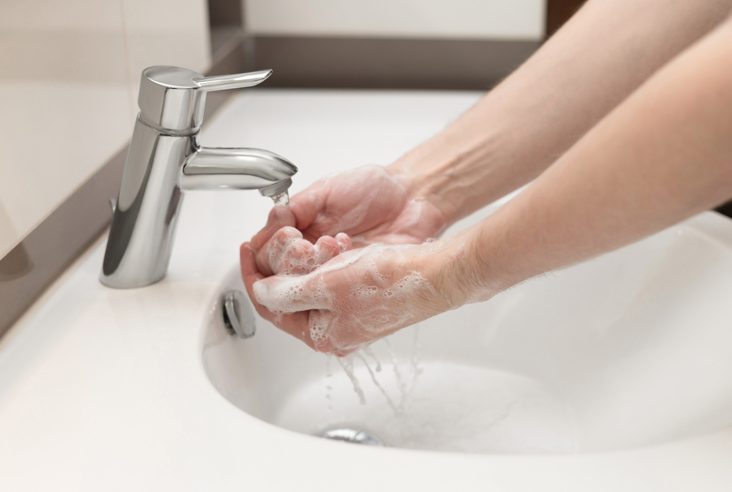 Hand washing concept. A man washes his hands in the bathroom with antibacterial soap. Personal hygiene. Health care and coronavirus protection.