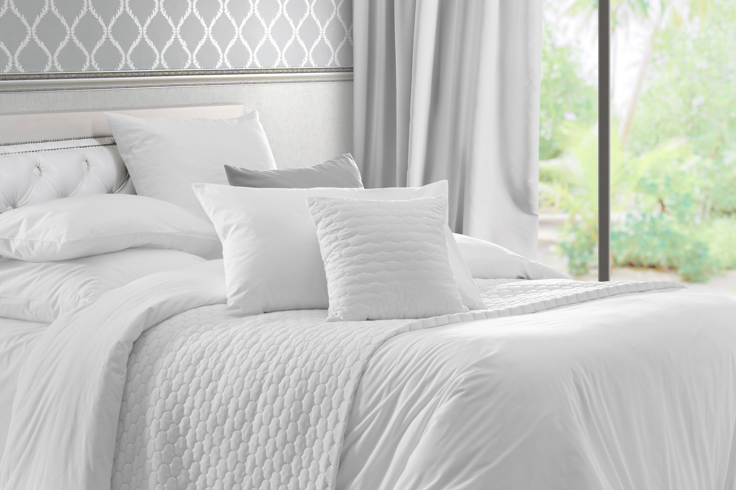 King bed with white linens and pillows