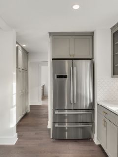 Kitchen Detail in Newly Remodeled Home: Hardwood Floors, Stainless Steel Refrigerator, Can You Put A Fridge On Carpet?
