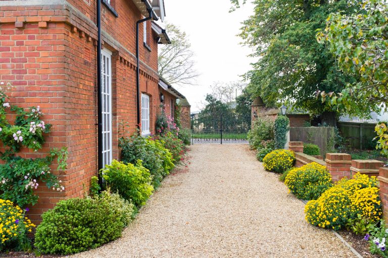 Large English country mansion house from Victorian period in the UK, with wrought iron gates and gravel drive, 11 Great Gravel Driveway Edging And Border Ideas