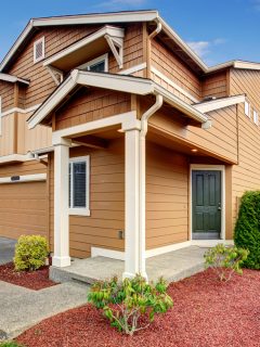Large tan house with white trim, garage, and big driveway - 11 Awesome Brown House Color Combinations