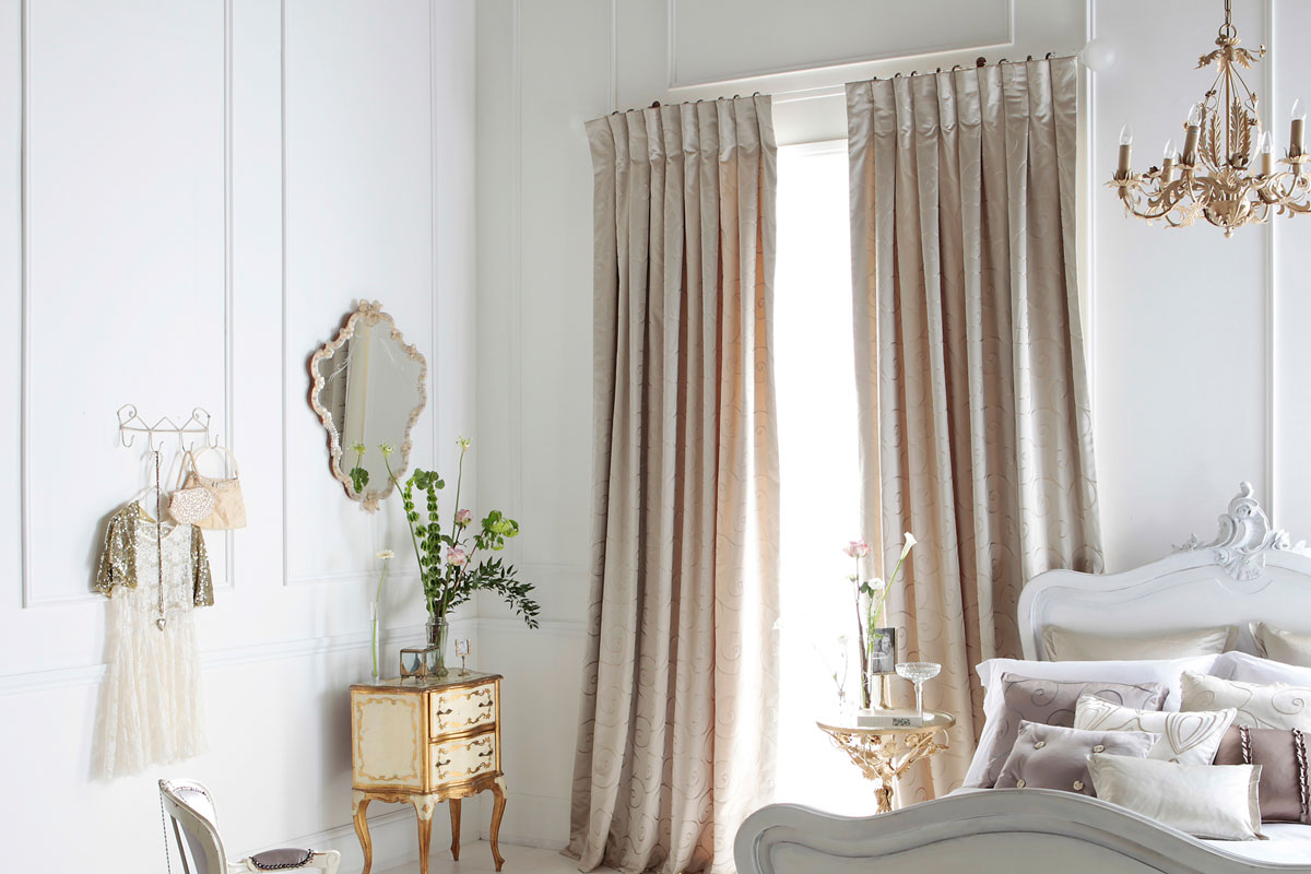 Light brown curtain in bedroom with luxurious furnitures and chandelier