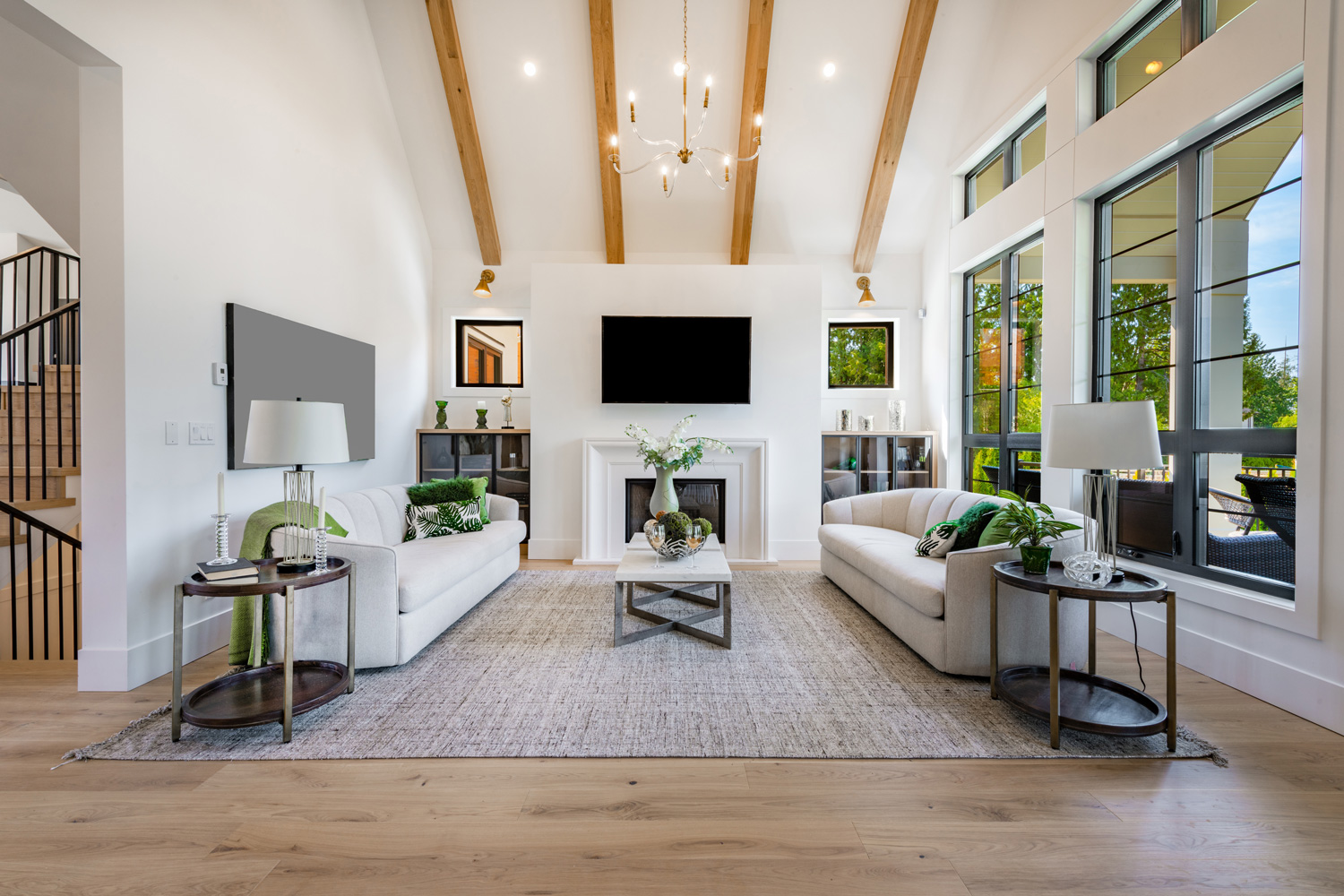 Modern farmhouse style living and family room with large windows cabinets in blues and greens