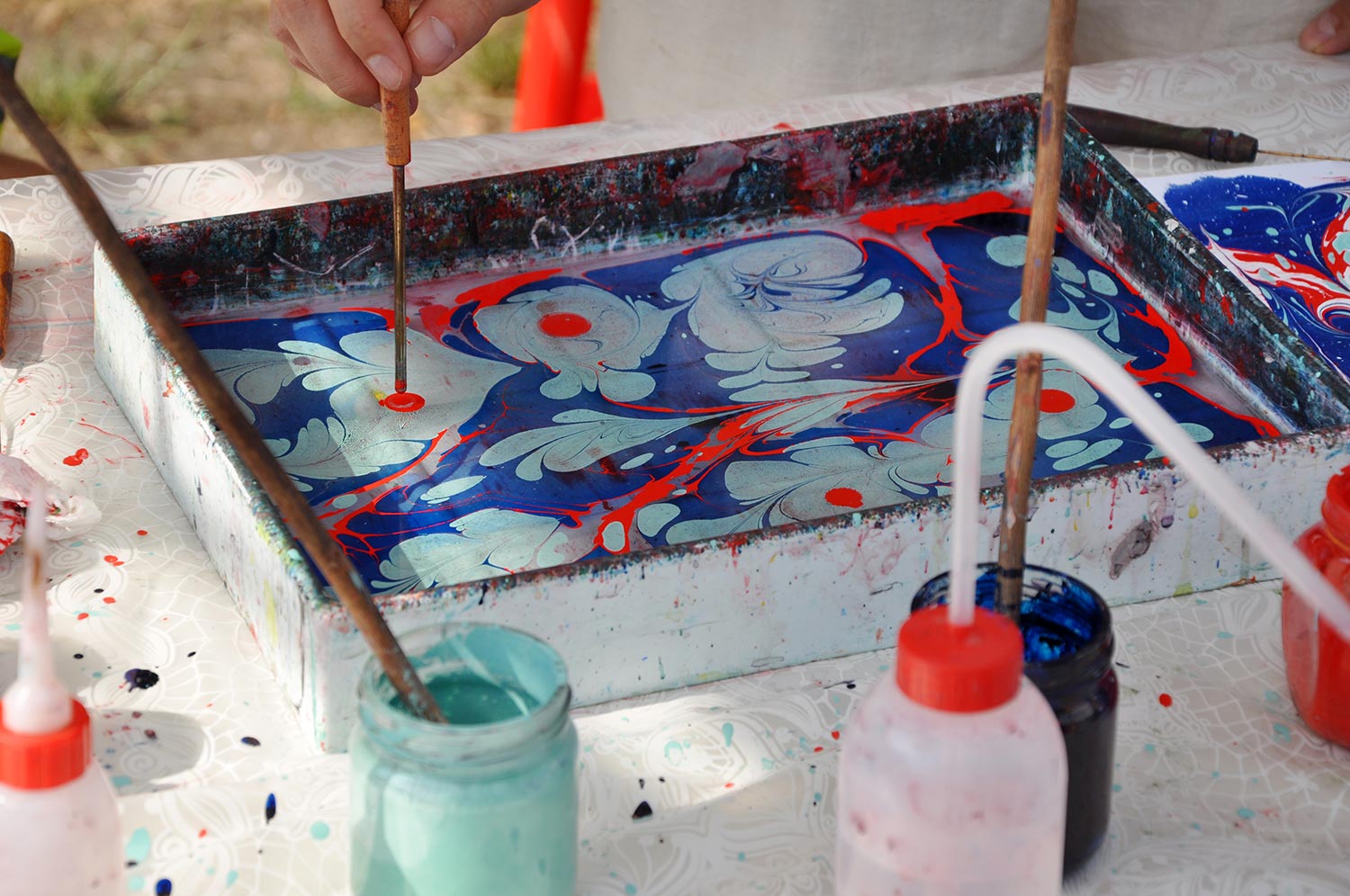 Oil-based inks in a tank of water prepared for marbling