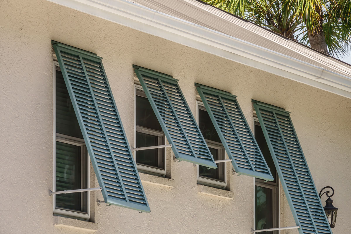 Storm shutters on side windows of a single-family house