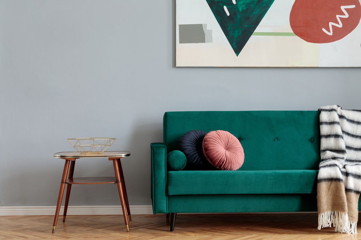 Stylish home interior with green velvet design sofa