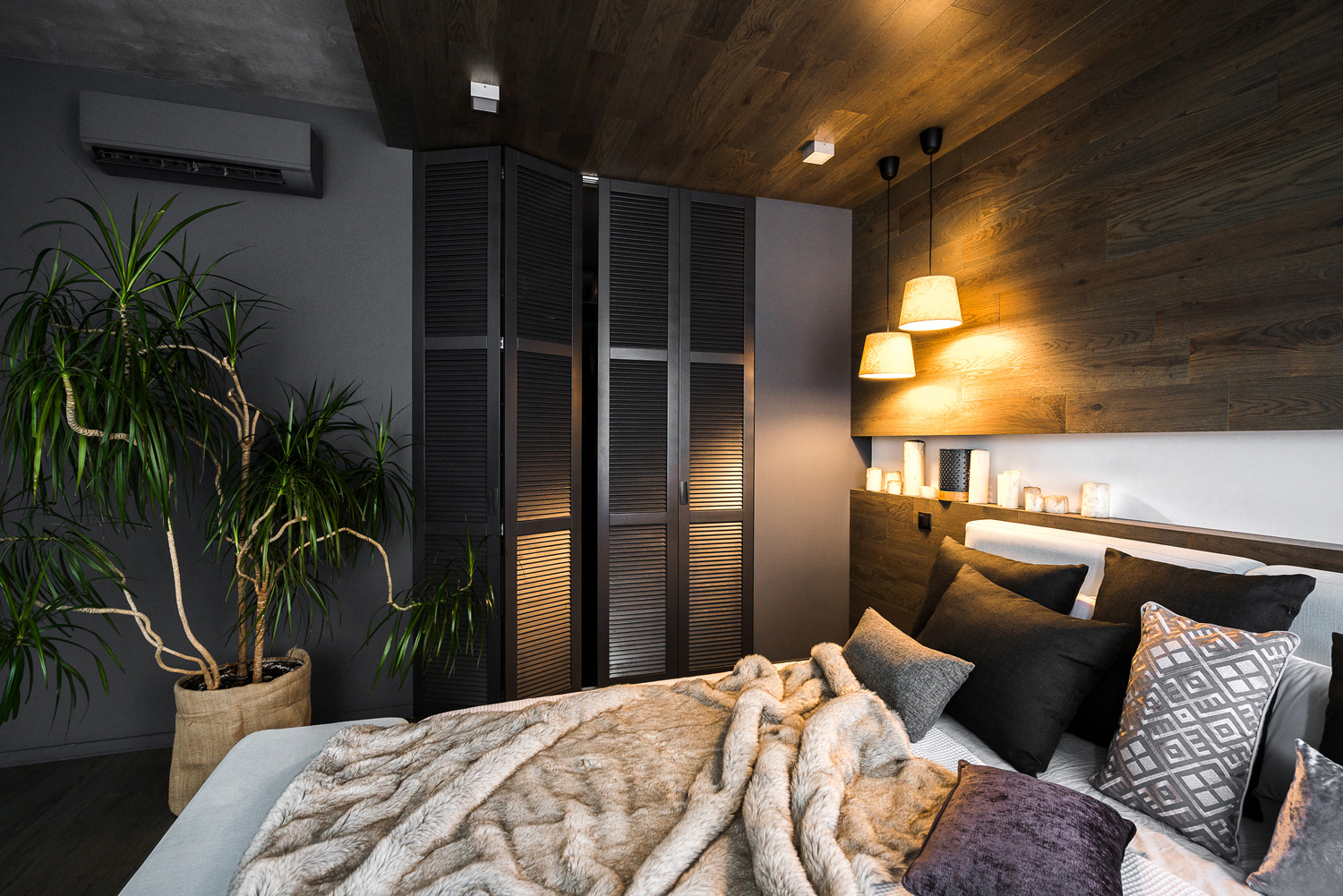 The interior of a stylish bedroom with a black wardrobe in dark colors. 