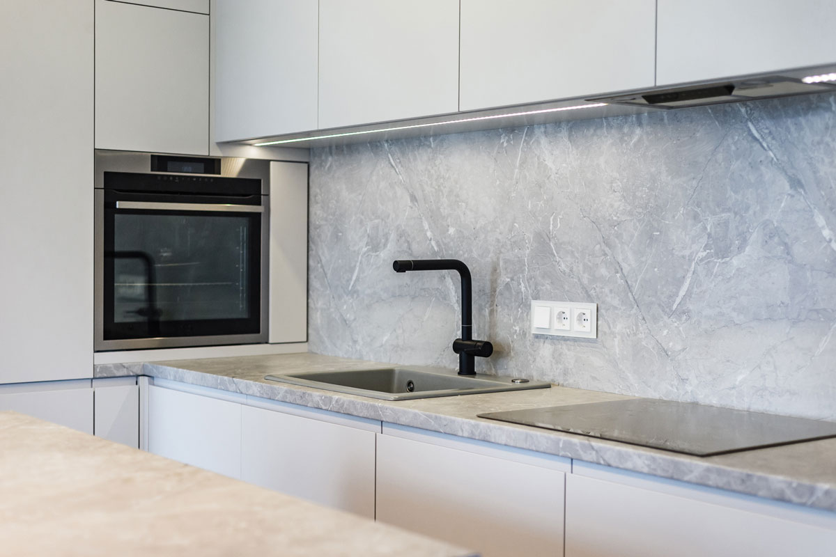 White cabinets with gray mixed white granite