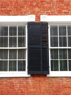A windows with black shutters on red brick house, What Color Shutters For A Red Brick House?