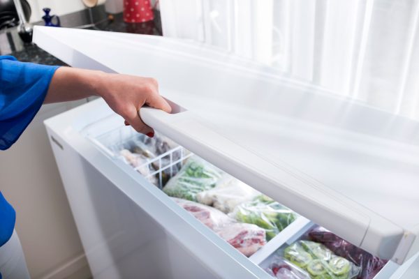 Woman opening a freezer, How To Find the Model Number on a Bosch Fridge Freezer