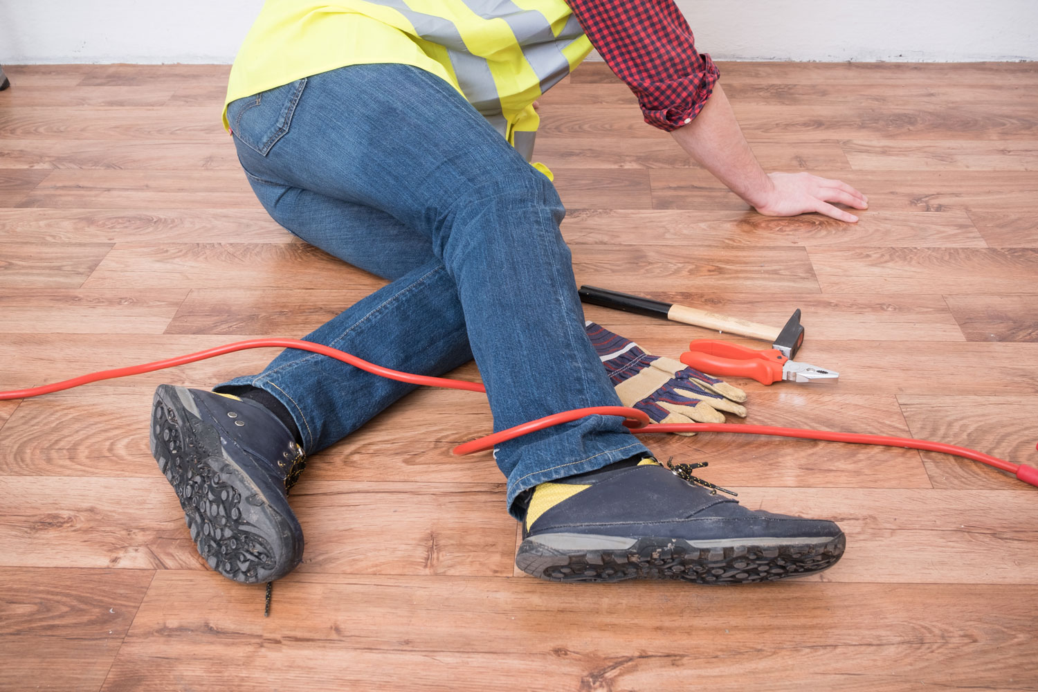 Worker tripping on a red extension cord