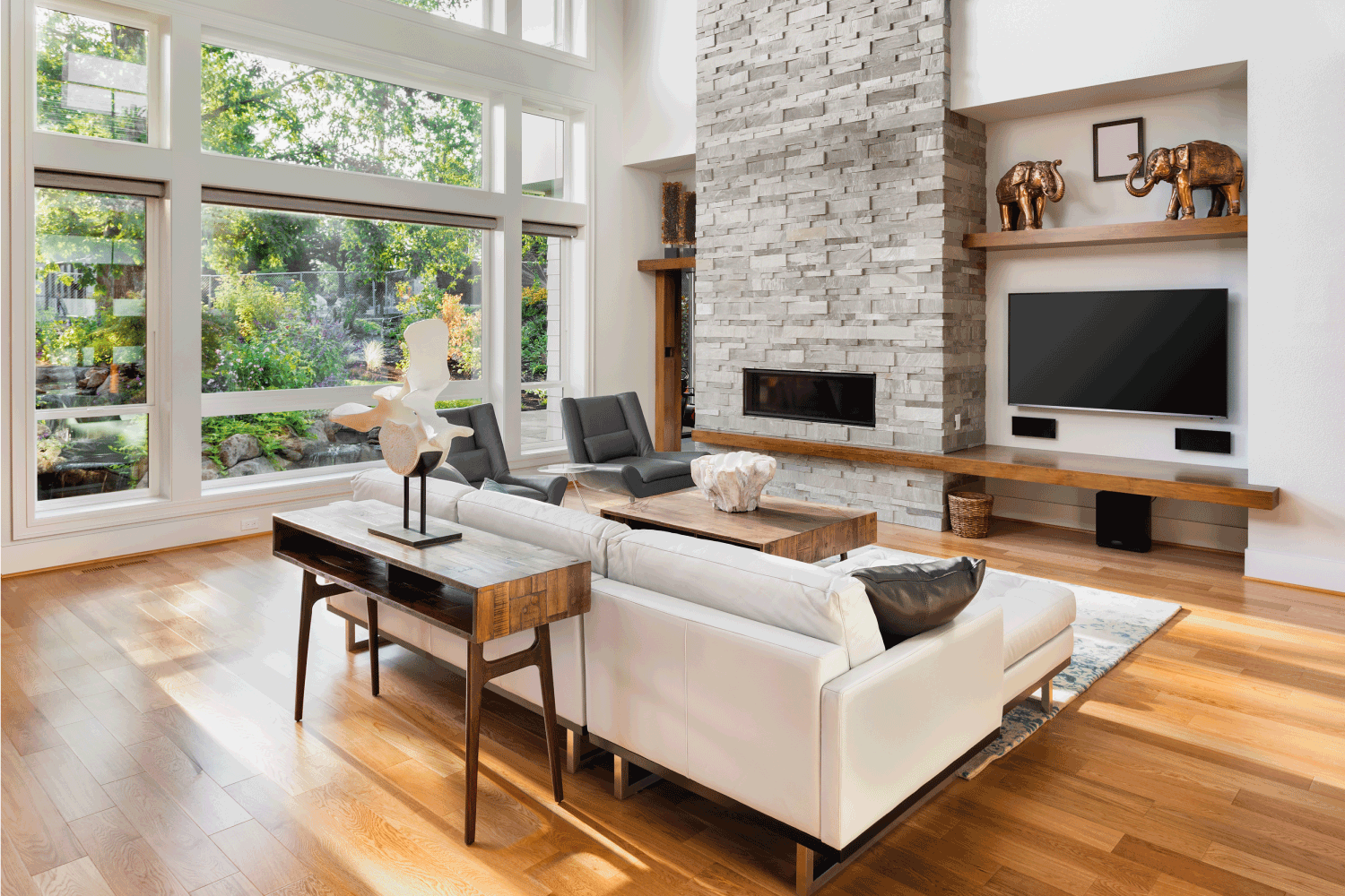 living room interior with hardwood floors and TV next to the fireplace