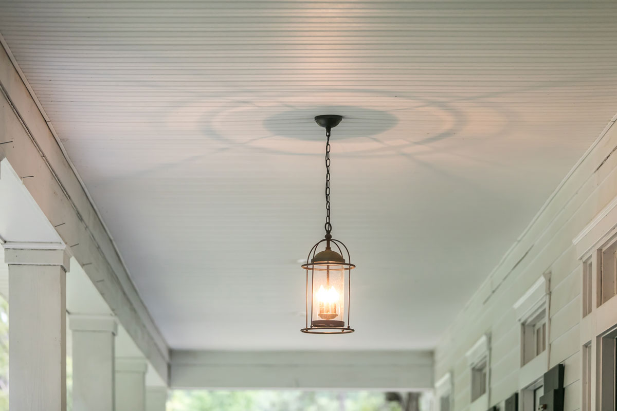 A decorative lamp hanged on the porch ceiling