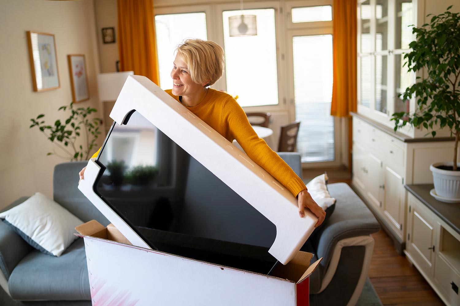 A female online shopper takes delivery of her new television