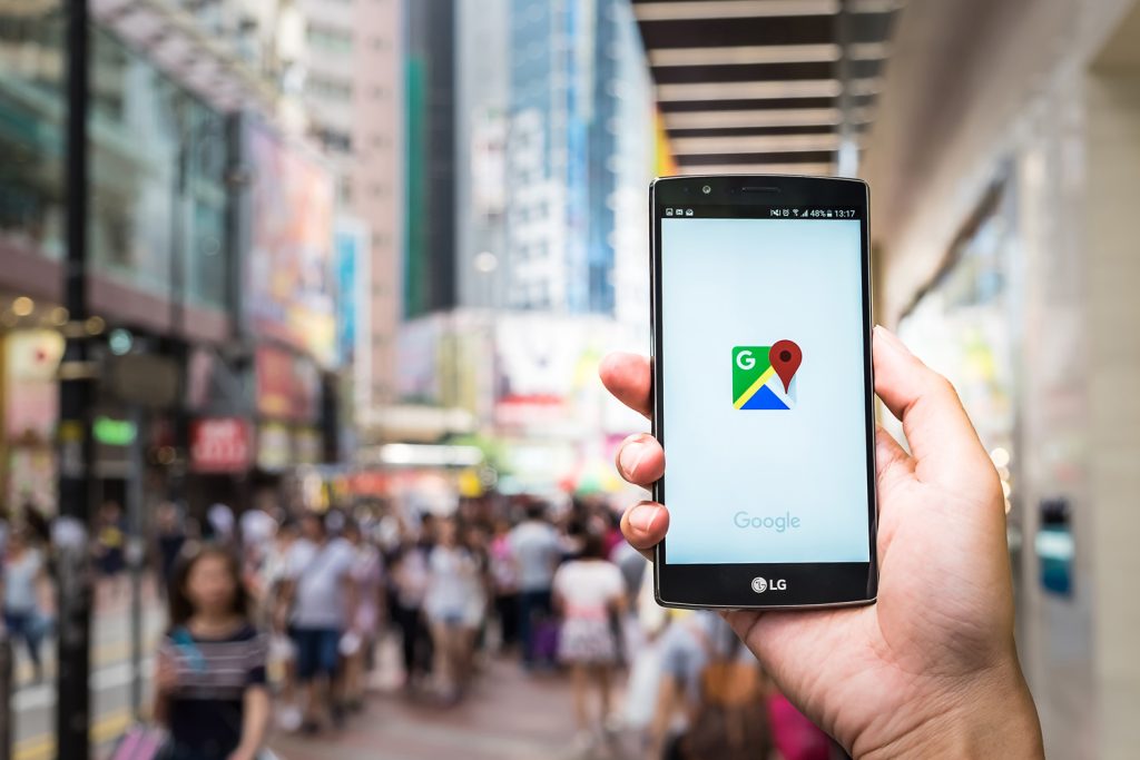 A man hand holding screen shot of google maps app showing on LG G4. 