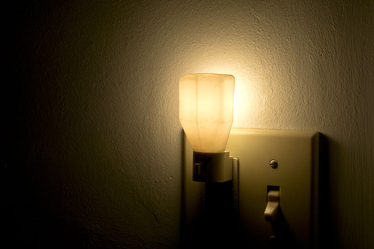 A night light plugged next to a switch