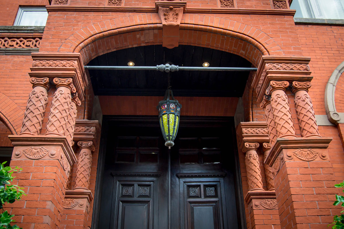 A red brick constructed building with a huge black french door