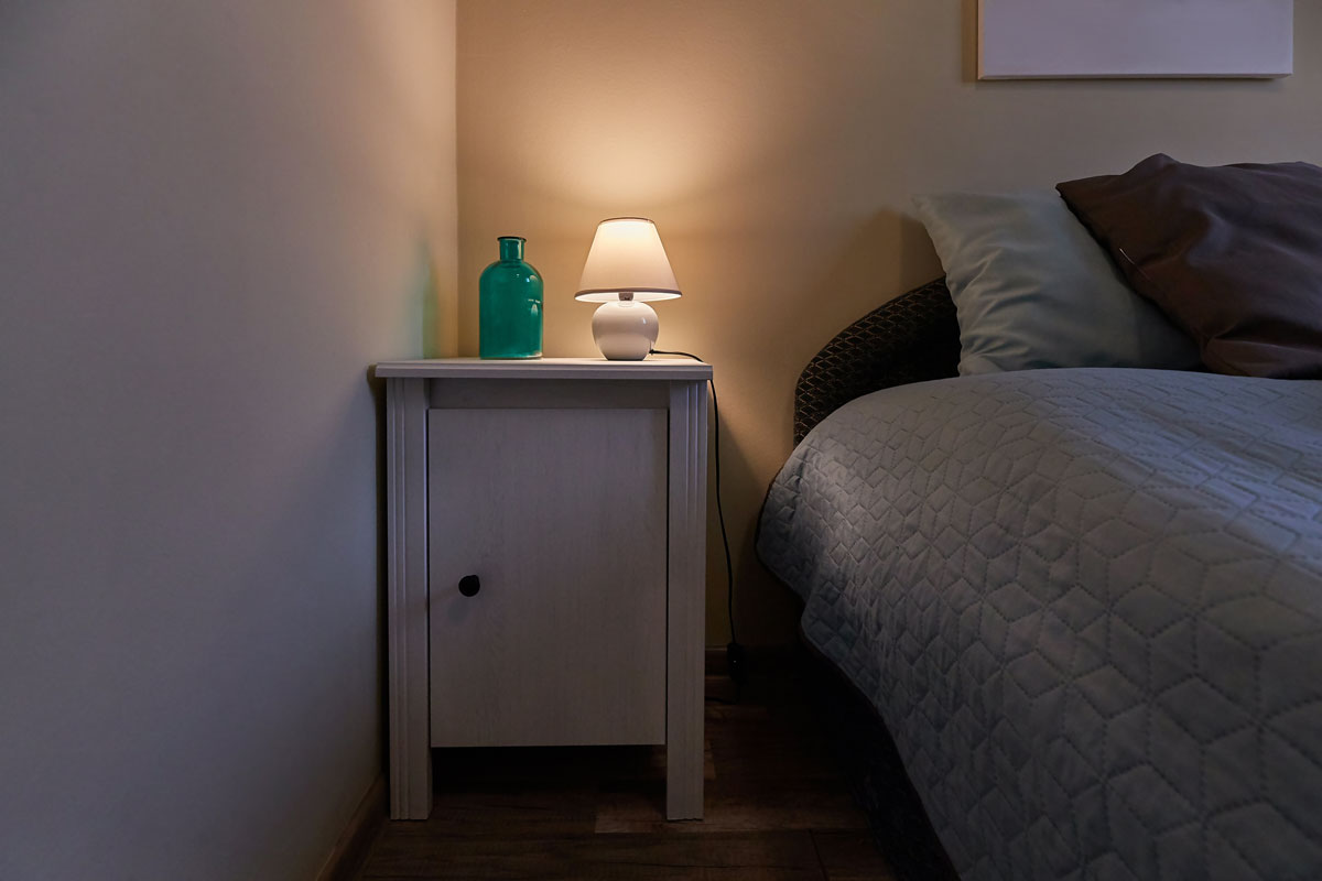 A small night light lamp on the bedside table
