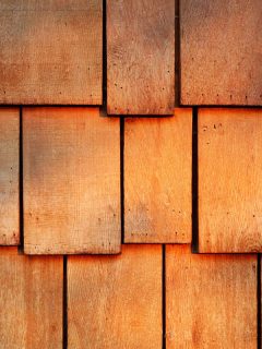Abstract wooden texture of red cedar shingles, shake wood siding row roof panel, What Colors Goes With Cedar Siding?