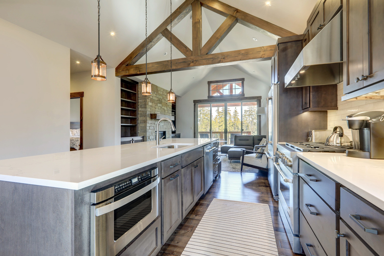 Amazing modern and rustic luxury kitchen with vaulted ceiling and wooden beams long island with white quarts countertop and dark wood cabinets