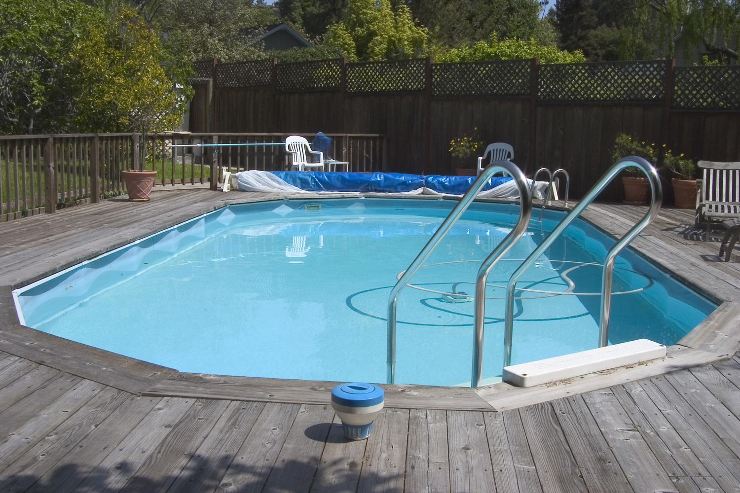 An above ground Doughboy swimming pool surrounded by decking.