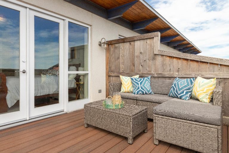 Apartment' outdoor patio with a couch and table, What's The Best Color For Patio Cushions?